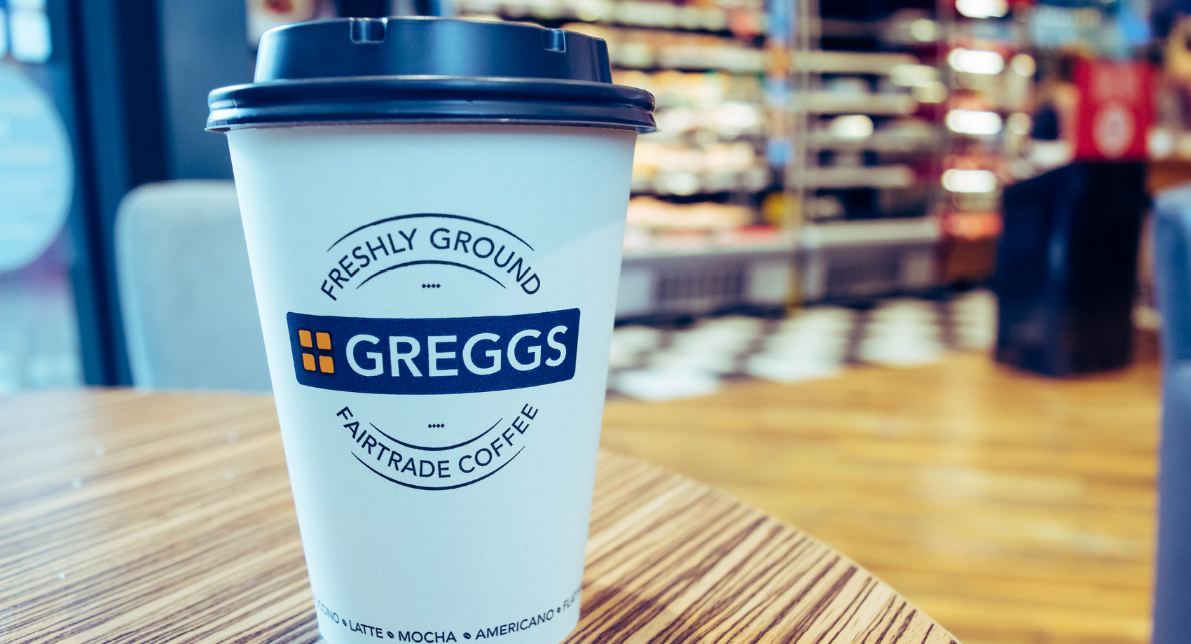 Greggs coffee cup on table