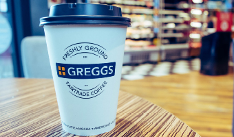 Greggs coffee cup on table