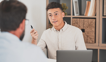 apprentice at work holding a pen