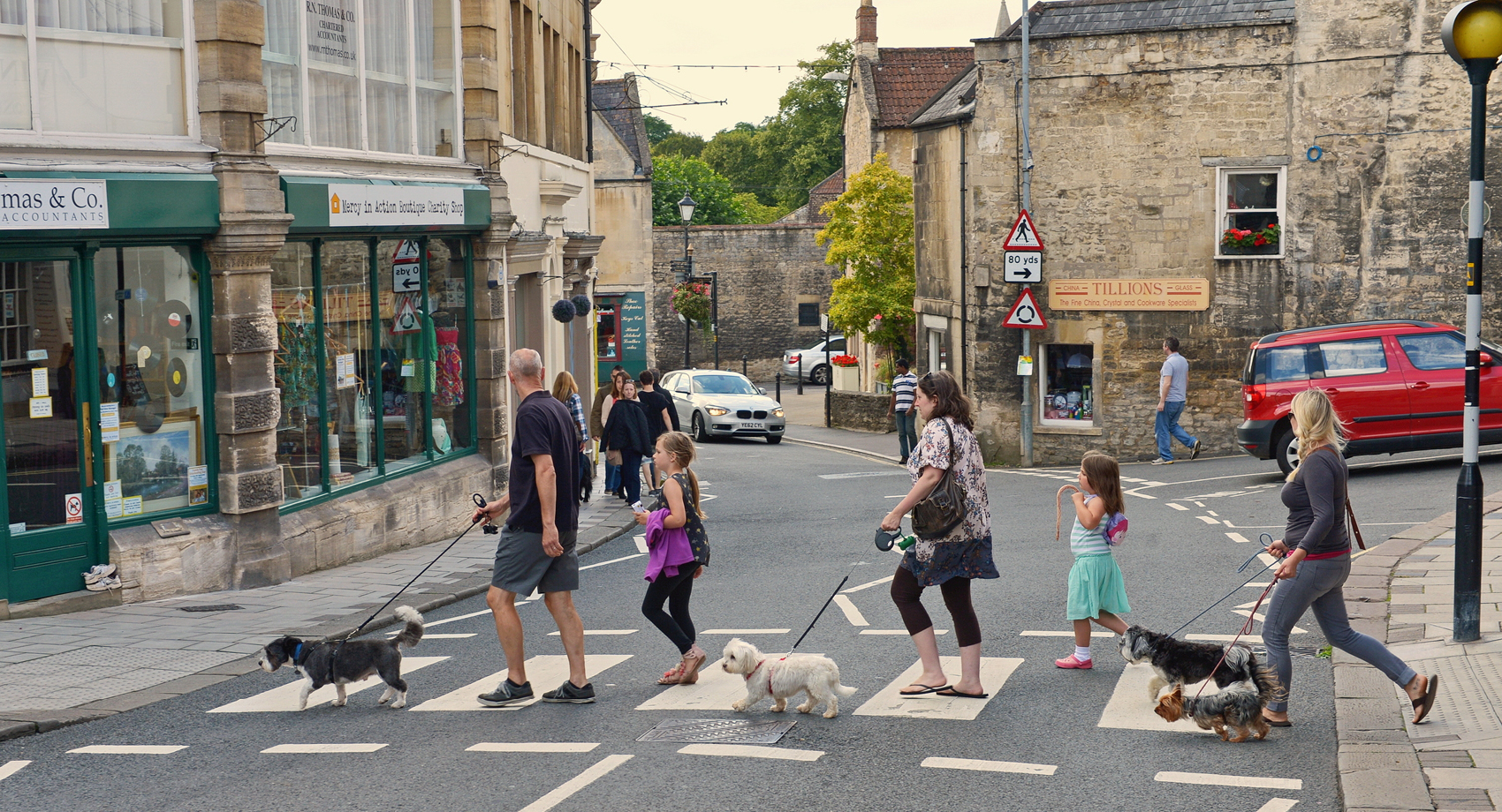 people crossing level crossing in town